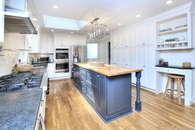 81 Grumman Hill Rd, Wilton, CT 06897 - kitchen with wooden counters, appliances with stainless steel finishes, white cabinets, exhaust hood, and recessed lighting