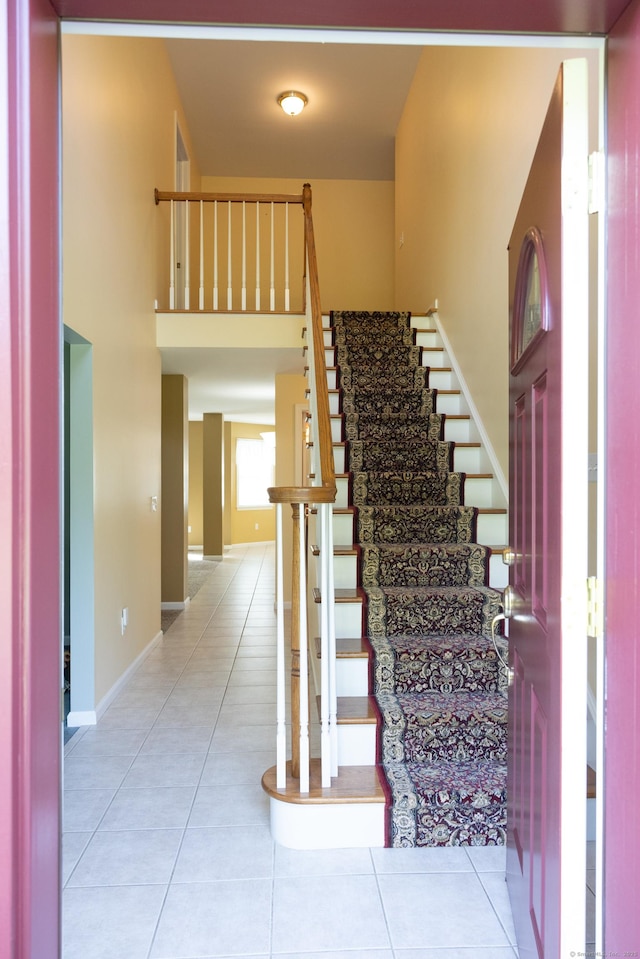 70 Wakeman Hill Rd, Sherman, CT 06784 - staircase with tile patterned floors, baseboards, and a towering ceiling