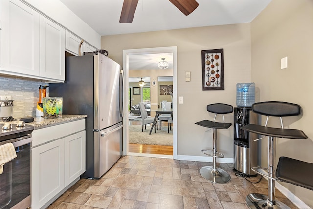 47 Currier Pl Unit 47, Cheshire, CT 06410 - kitchen featuring a ceiling fan, stainless steel appliances, backsplash, and baseboards