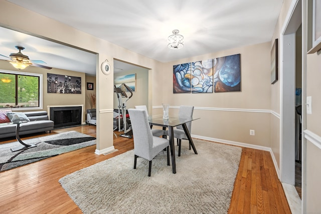 47 Currier Pl Unit 47, Cheshire, CT 06410 - dining space with wood finished floors, baseboards, a fireplace with flush hearth, and a ceiling fan