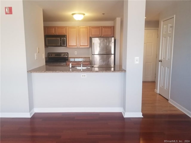 300 Broad St Unit 908, Stamford, CT 06902 - kitchen featuring appliances with stainless steel finishes, a peninsula, wood finished floors, and light brown cabinetry