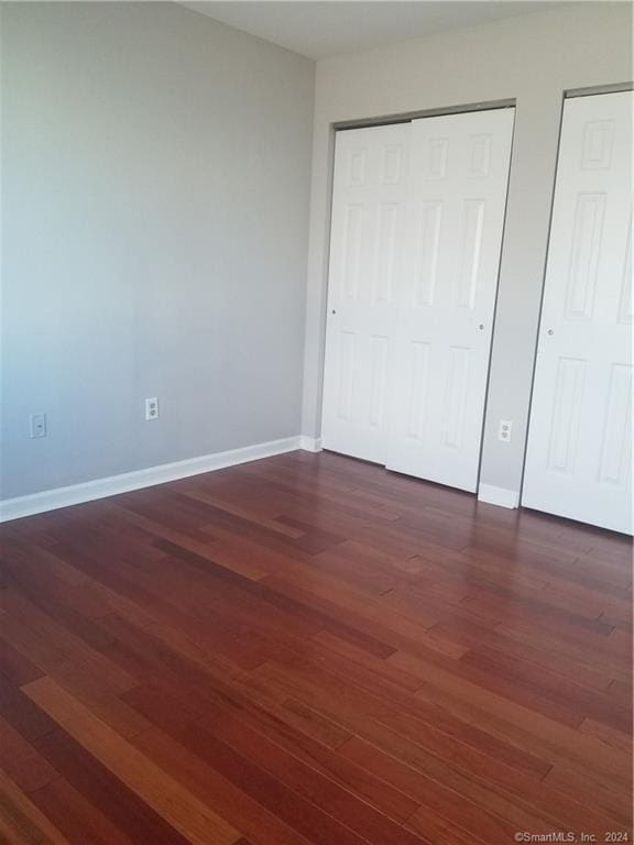 300 Broad St Unit 908, Stamford, CT 06902 - unfurnished bedroom with dark wood finished floors and baseboards