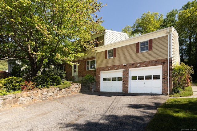48 Lafayette Dr, Trumbull, CT 06611 - view of front of home featuring driveway, a garage, and brick siding