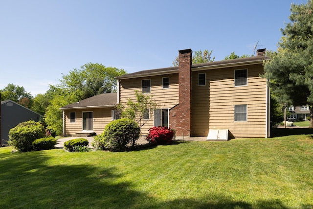 48 Lafayette Dr, Trumbull, CT 06611 - rear view of house featuring a chimney and a lawn