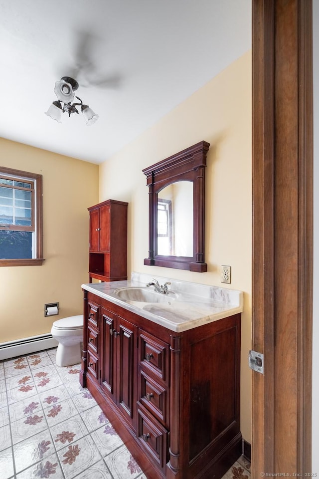 48 Lafayette Dr, Trumbull, CT 06611 - bathroom with toilet, vanity, a baseboard radiator, and a ceiling fan