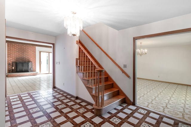 48 Lafayette Dr, Trumbull, CT 06611 - stairs with a chandelier, tile patterned floors, baseboards, and a fireplace