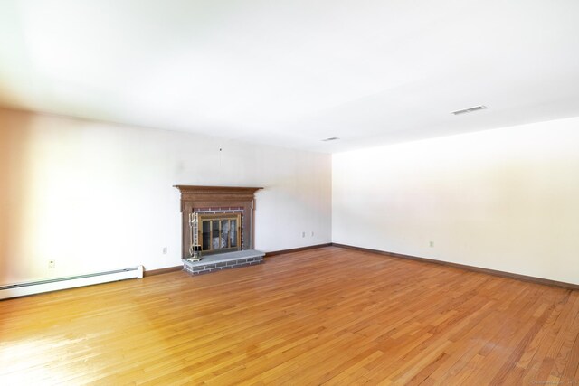 48 Lafayette Dr, Trumbull, CT 06611 - unfurnished living room featuring light wood finished floors, a brick fireplace, a baseboard heating unit, and baseboards
