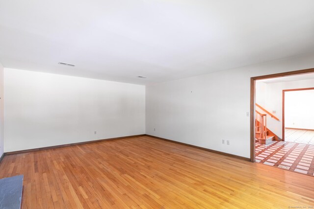 48 Lafayette Dr, Trumbull, CT 06611 - empty room featuring light wood-style flooring, stairs, and baseboards