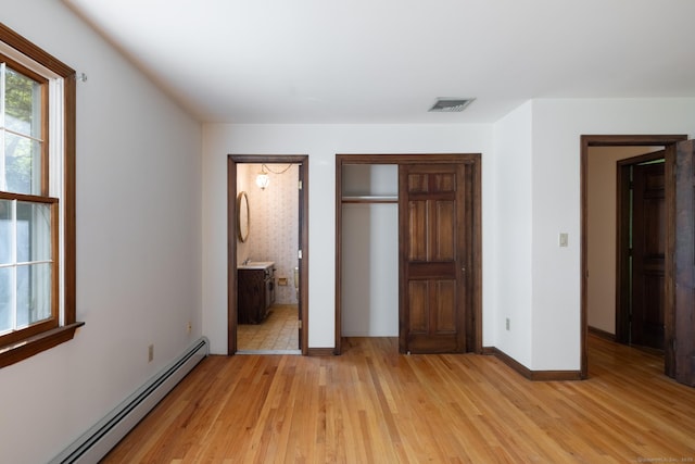 48 Lafayette Dr, Trumbull, CT 06611 - unfurnished bedroom with baseboard heating, light wood-style flooring, a closet, and baseboards