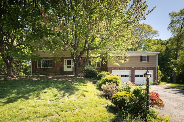 48 Lafayette Dr, Trumbull, CT 06611 - view of front of house with brick siding, asphalt driveway, an attached garage, and a front yard