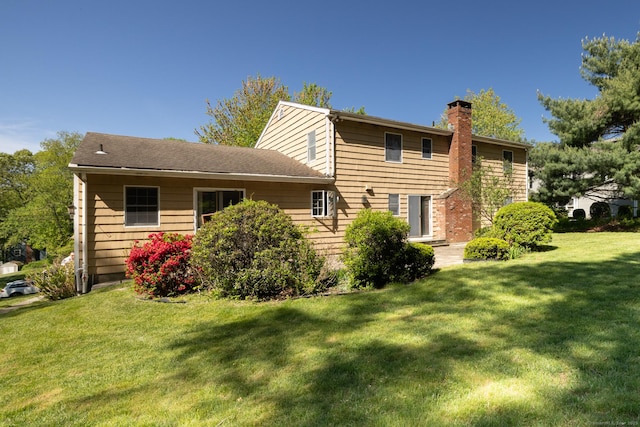 48 Lafayette Dr, Trumbull, CT 06611 - rear view of property with a chimney and a yard