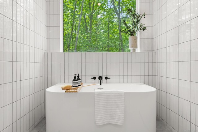 19 Old Paddock Ln, Kent, CT 06785 - bathroom with tile walls, a soaking tub, and plenty of natural light