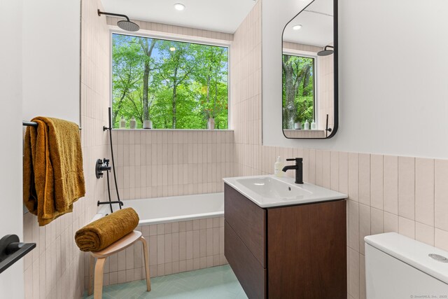 19 Old Paddock Ln, Kent, CT 06785 - full bathroom with tile walls, vanity, tiled bath, toilet, and tile patterned flooring