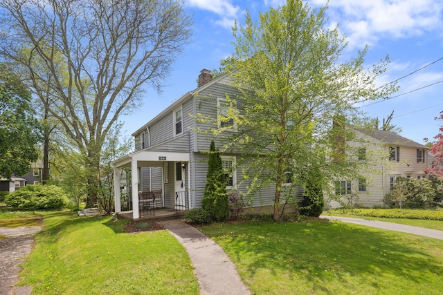 101 White Ave, West Hartford, CT 06119 - view of front facade with a porch, a chimney, and a front lawn