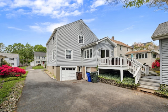 101 White Ave, West Hartford, CT 06119 - view of home's exterior featuring asphalt driveway, an attached garage, and a wooden deck