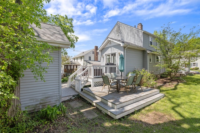 101 White Ave, West Hartford, CT 06119 - rear view of house featuring a chimney, a wooden deck, a lawn, and outdoor dining space