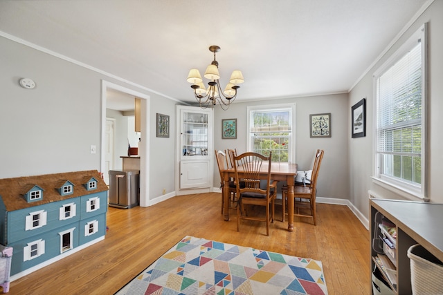 101 White Ave, West Hartford, CT 06119 - dining area featuring a chandelier, crown molding, light wood finished floors, and baseboards