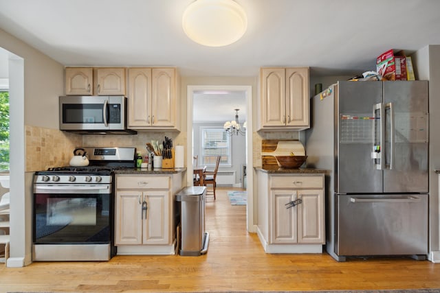 101 White Ave, West Hartford, CT 06119 - kitchen featuring appliances with stainless steel finishes, plenty of natural light, light wood-type flooring, and tasteful backsplash