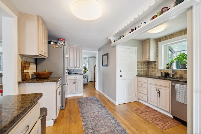 101 White Ave, West Hartford, CT 06119 - kitchen with stainless steel appliances, light wood-style floors, tasteful backsplash, a sink, and baseboards