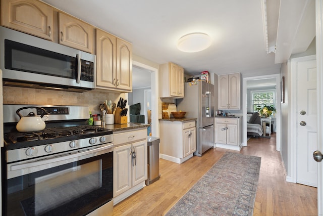 101 White Ave, West Hartford, CT 06119 - kitchen featuring stainless steel appliances, light wood finished floors, and decorative backsplash
