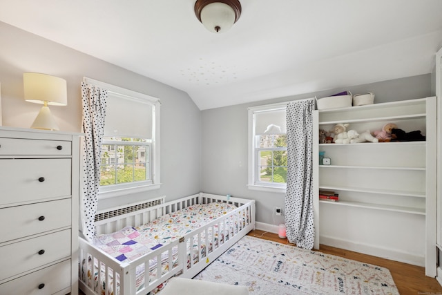 101 White Ave, West Hartford, CT 06119 - bedroom featuring lofted ceiling, baseboards, wood finished floors, and radiator