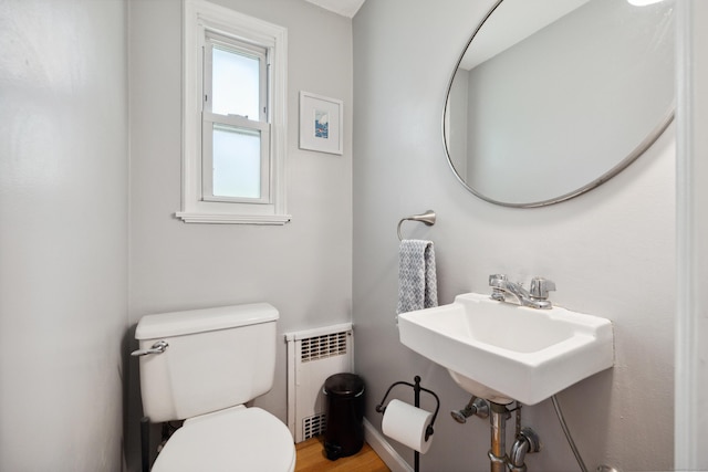 101 White Ave, West Hartford, CT 06119 - bathroom featuring radiator heating unit, toilet, a sink, and wood finished floors