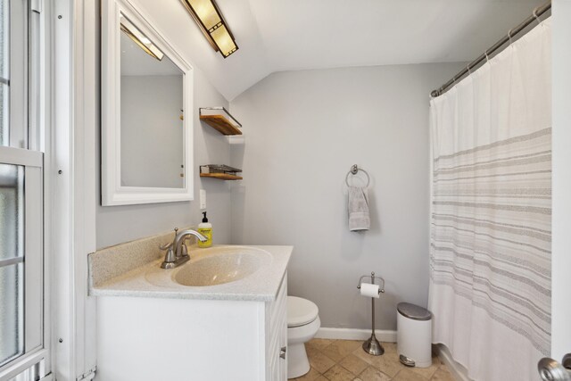 101 White Ave, West Hartford, CT 06119 - bathroom featuring toilet, vanity, baseboards, and vaulted ceiling