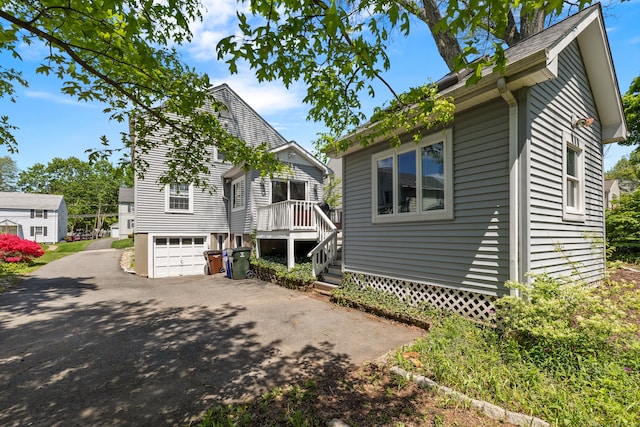 101 White Ave, West Hartford, CT 06119 - view of front of home featuring driveway, a garage, and a wooden deck