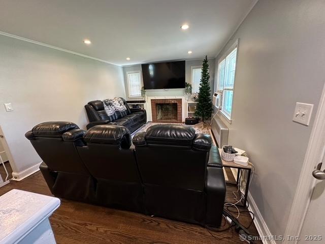 794 Center St, Manchester, CT 06040 - home theater room featuring a fireplace, baseboards, recessed lighting, crown molding, and wood finished floors