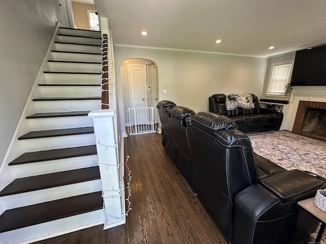 794 Center St, Manchester, CT 06040 - living area featuring arched walkways, dark wood-type flooring, ornamental molding, a brick fireplace, and recessed lighting