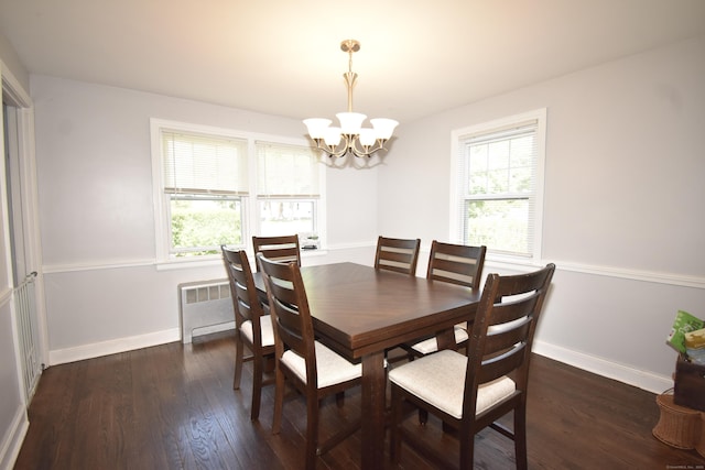 794 Center St, Manchester, CT 06040 - dining area featuring a chandelier, wood finished floors, baseboards, and radiator heating unit