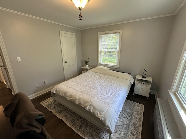 794 Center St, Manchester, CT 06040 - bedroom with dark wood finished floors, multiple windows, crown molding, and baseboards