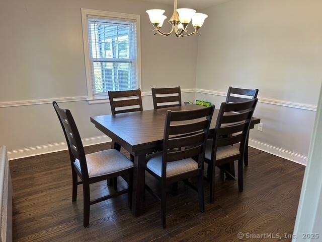 794 Center St, Manchester, CT 06040 - dining area with a chandelier, dark wood-style flooring, and baseboards