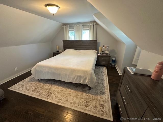 794 Center St, Manchester, CT 06040 - bedroom with dark wood-type flooring, vaulted ceiling, and baseboards