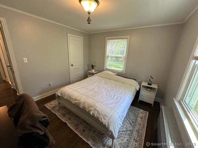 794 Center St, Manchester, CT 06040 - bedroom featuring multiple windows, dark wood finished floors, ornamental molding, and baseboards