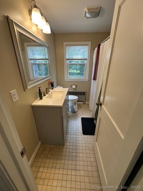 794 Center St, Manchester, CT 06040 - bathroom featuring radiator heating unit, toilet, tile patterned flooring, vanity, and baseboards