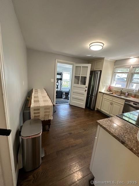 794 Center St, Manchester, CT 06040 - kitchen featuring appliances with stainless steel finishes, dark wood-style flooring, a sink, and stone countertops