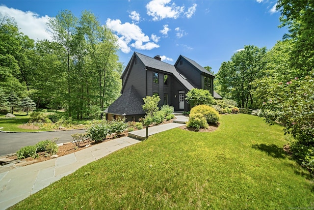 31 Poverty Hollow Rd, Newtown, CT 06470 - view of front of property with a front yard, a shingled roof, and a chimney