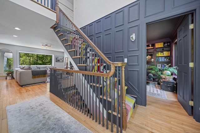31 Poverty Hollow Rd, Newtown, CT 06470 - stairway featuring hardwood / wood-style flooring, arched walkways, and recessed lighting