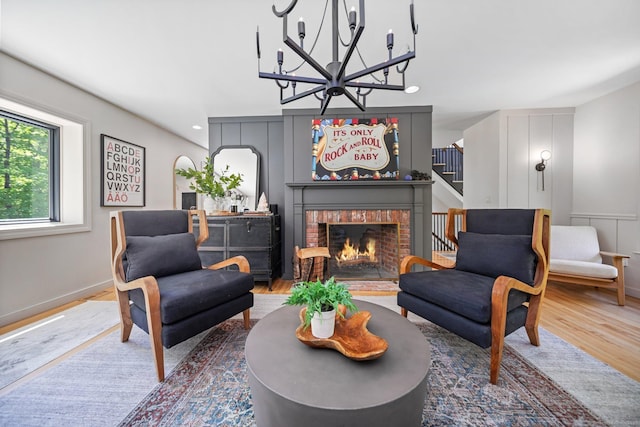 31 Poverty Hollow Rd, Newtown, CT 06470 - living room featuring wood finished floors, a chandelier, a fireplace, stairway, and baseboards
