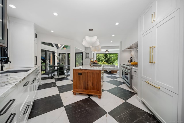 31 Poverty Hollow Rd, Newtown, CT 06470 - kitchen with range with two ovens, a sink, recessed lighting, white cabinets, and open floor plan