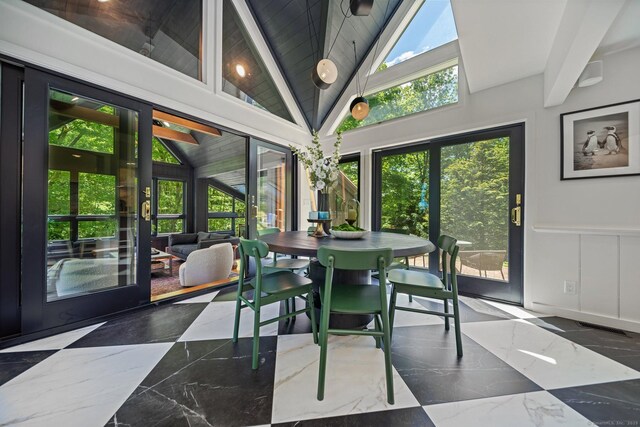 31 Poverty Hollow Rd, Newtown, CT 06470 - dining area featuring marble tiled flooring, a wainscoted wall, vaulted ceiling, and a decorative wall