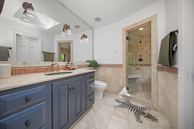 31 Poverty Hollow Rd, Newtown, CT 06470 - bathroom featuring a skylight, tile walls, toilet, a stall shower, and vanity