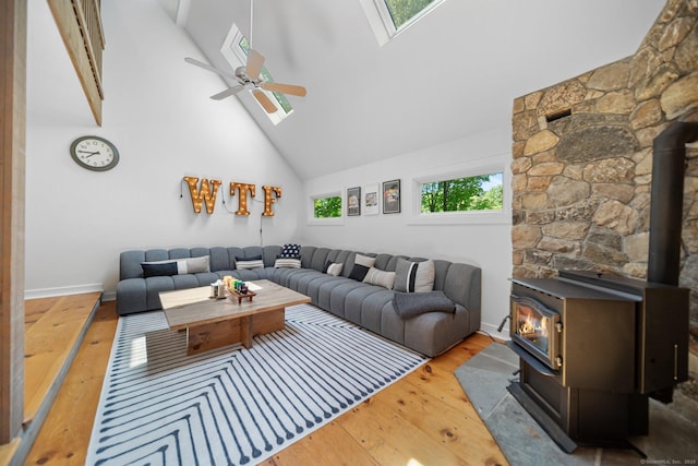 31 Poverty Hollow Rd, Newtown, CT 06470 - living area featuring a wood stove, a skylight, high vaulted ceiling, wood-type flooring, and ceiling fan