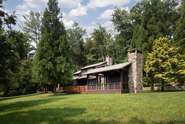 20 Kirk Rd, Sharon, CT 06796 - rear view of house featuring a chimney, a lawn, a sunroom, and a deck