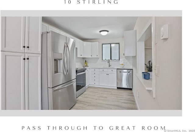 10 Stirling Ct, Middletown, CT 06457 - kitchen with appliances with stainless steel finishes, a sink, white cabinets, and backsplash