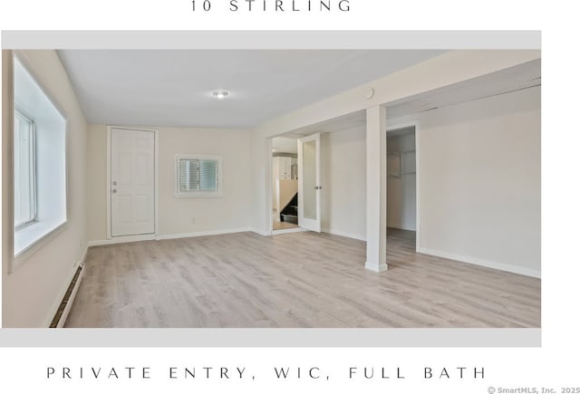 10 Stirling Ct, Middletown, CT 06457 - unfurnished living room with a baseboard radiator, wood finished floors, stairs, and baseboards