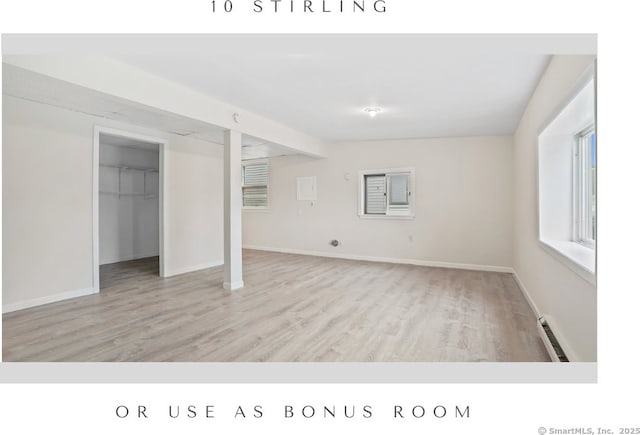 10 Stirling Ct, Middletown, CT 06457 - unfurnished living room featuring wood finished floors, baseboards, and baseboard heating