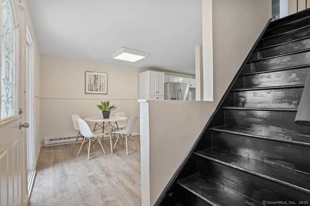 10 Stirling Ct, Middletown, CT 06457 - stairway featuring wood finished floors and a baseboard heating unit