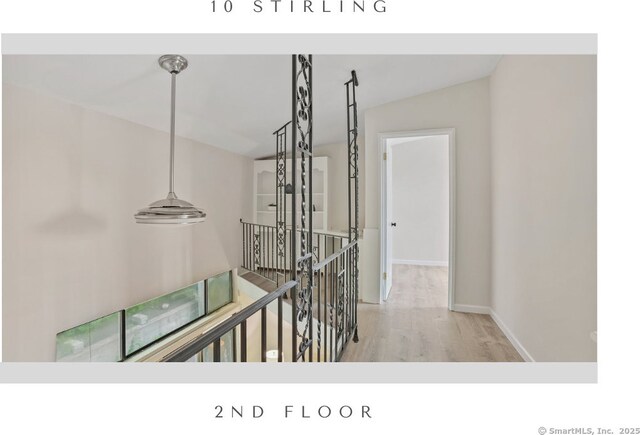 10 Stirling Ct, Middletown, CT 06457 - hall with an upstairs landing, wood finished floors, and baseboards